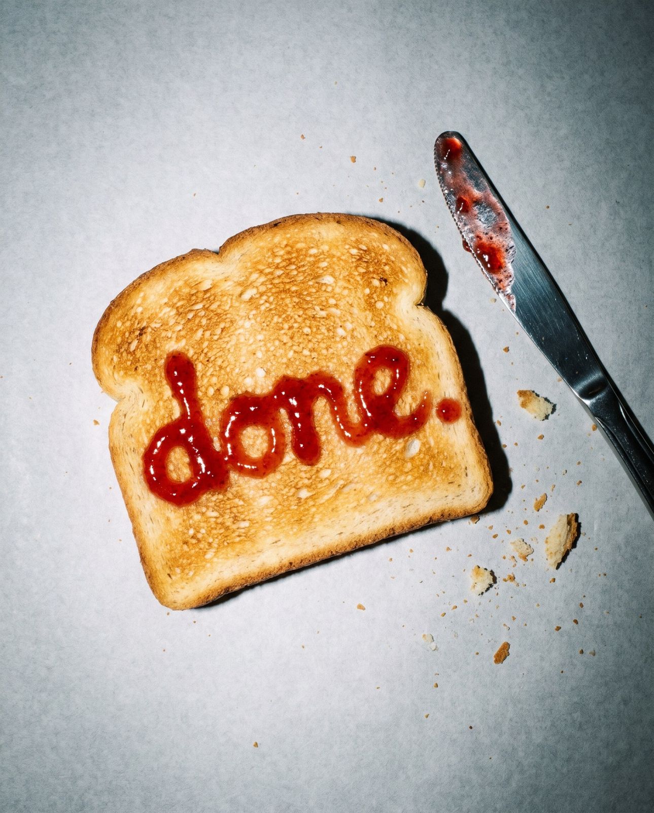 a slice of toast with done. written on it in jam